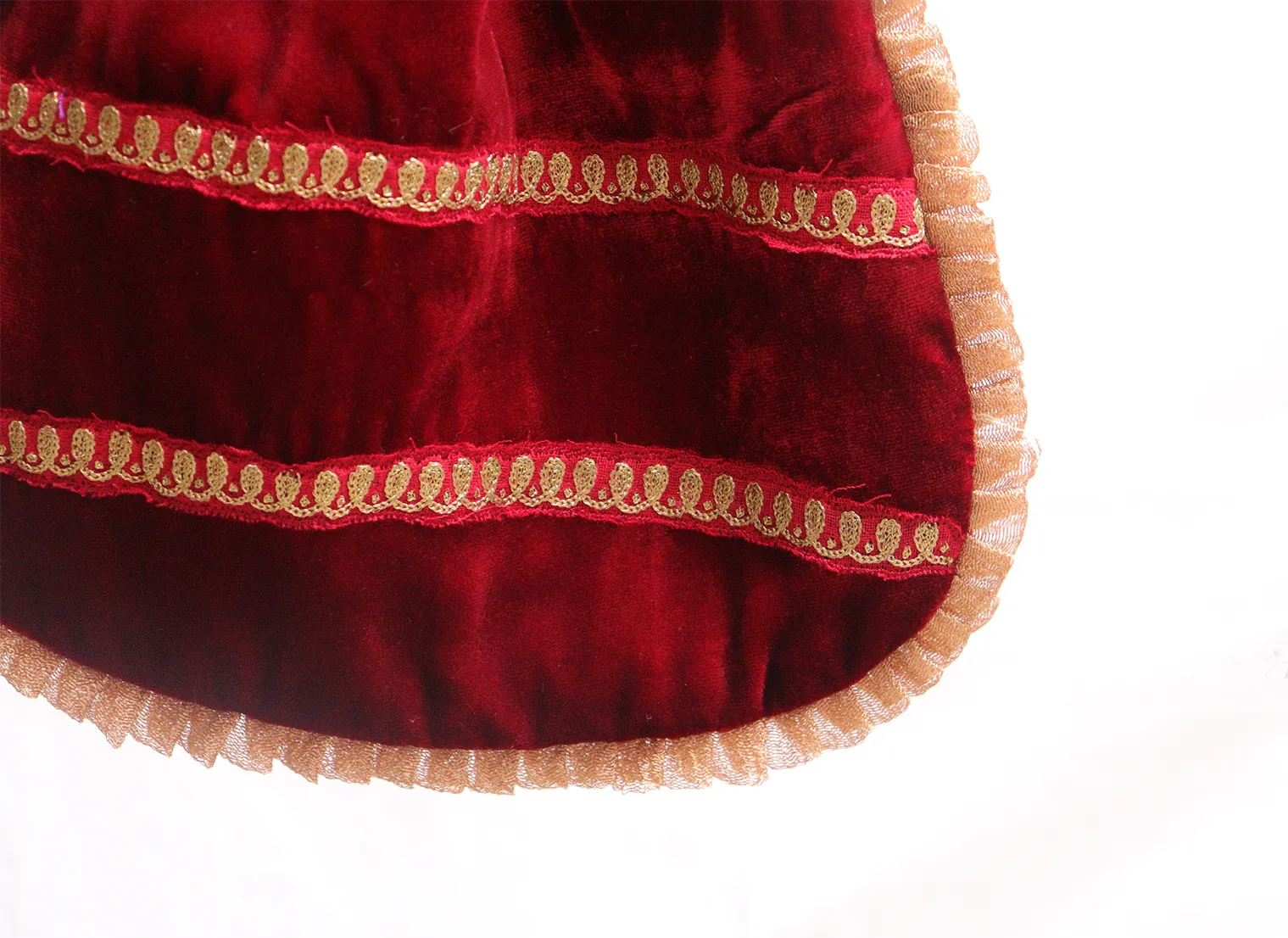 Blood red velvet potli with gold jari embroidery.